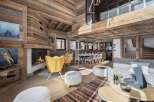 Experience luxury living in this stunning chalet, featuring a cozy fireplace and elegant wooden accents throughout.