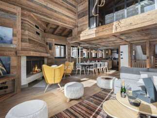 Experience luxury living in this stunning chalet, featuring a cozy fireplace and elegant wooden accents throughout.