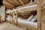 Discover the charm of this cozy bunk room, perfect for accommodating guests.