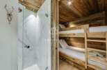 Discover luxury living in this stunning property! Featuring a modern shower and cozy bunk beds, perfect for guests.