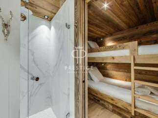 Discover luxury living in this stunning property! Featuring a modern shower and cozy bunk beds, perfect for guests.