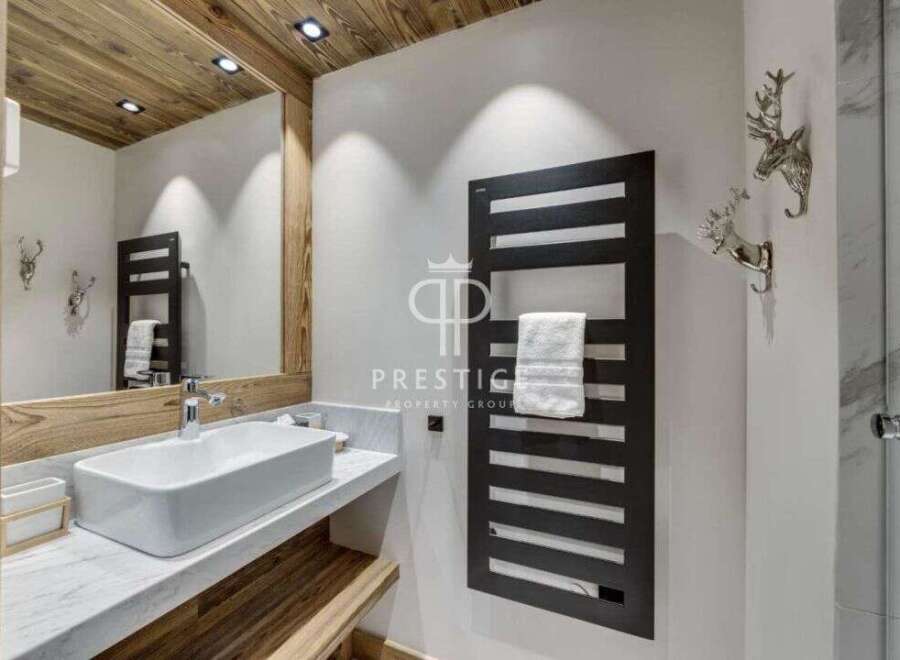 Discover luxury living in this stunning property, featuring a modern bathroom design.
