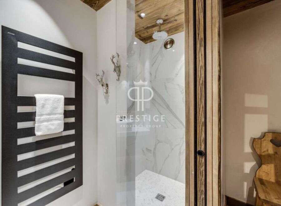 Discover luxury living at its finest! This stunning property boasts a modern bathroom with a sleek heated towel rack and a luxurious walk-in shower.