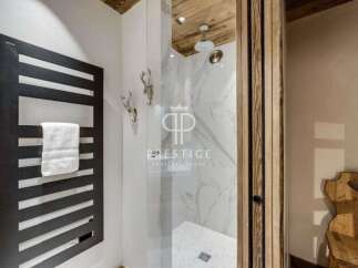 Discover luxury living at its finest! This stunning property boasts a modern bathroom with a sleek heated towel rack and a luxurious walk-in shower.