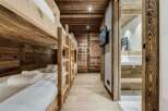 Experience the warmth of this stunning wooden-clad property, featuring cozy bunk beds perfect for a family getaway.