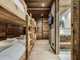 Experience the warmth of this stunning wooden-clad property, featuring cozy bunk beds perfect for a family getaway.