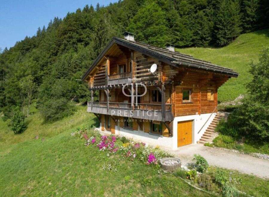Discover a stunning wooden chalet nestled in a picturesque mountain setting.