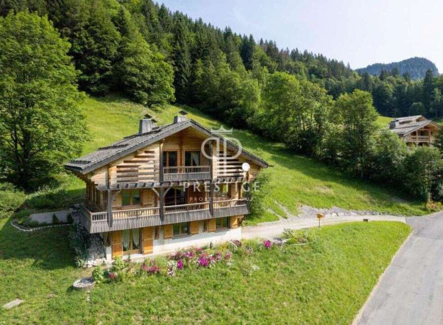 Discover a stunning wooden chalet nestled in a picturesque mountain setting.