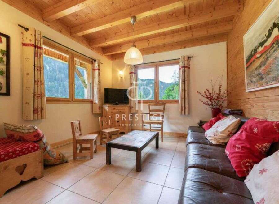 Discover the charm of this cozy property, featuring a warm wooden interior and inviting living spaces.