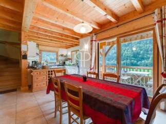 Experience the charm of this stunning property, featuring a warm and inviting interior with exposed wooden beams.