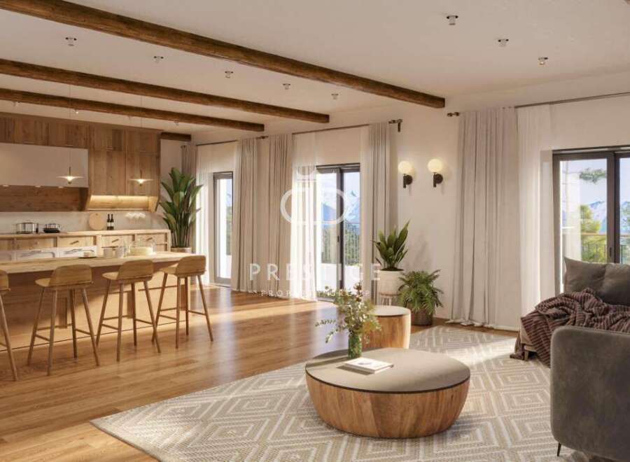 Experience luxury living in this stunning property, featuring a modern kitchen with a breakfast bar and a cozy living area.