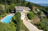 Discover a stunning property nestled in a picturesque landscape, boasting a private swimming pool and lush greenery.