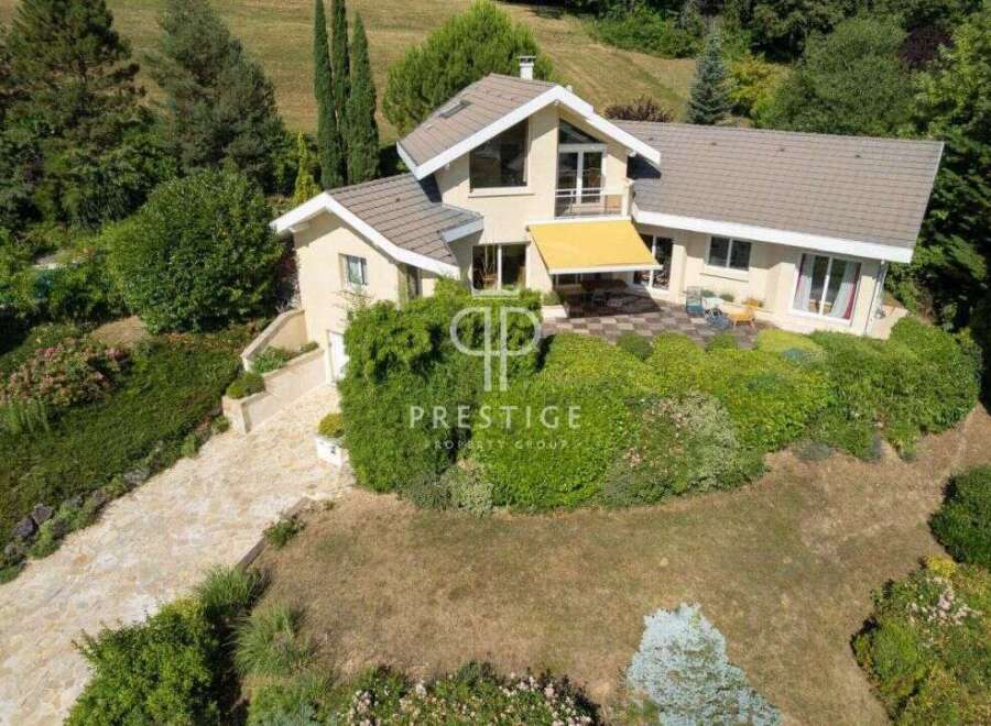 Discover a stunning property nestled in a serene, green landscape.