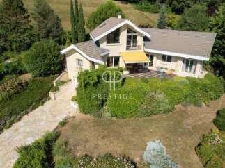 Discover a stunning property nestled in a serene, green landscape.