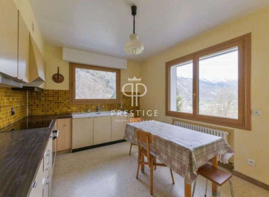Discover a charming kitchen with a cozy dining area, perfect for enjoying meals with a view.