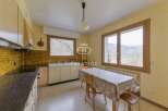 Discover a charming kitchen with a cozy dining area, perfect for enjoying meals with a view.