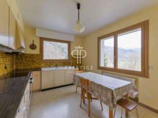 Discover a charming kitchen with a cozy dining area, perfect for enjoying meals with a view.
