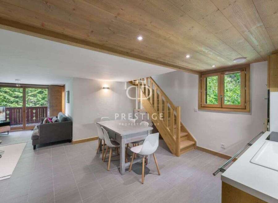 Discover a charming property featuring a cozy living space with a modern dining area.