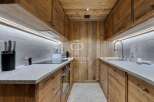 Experience the warmth of this stunning kitchen, featuring custom wooden cabinetry and a sleek countertop.