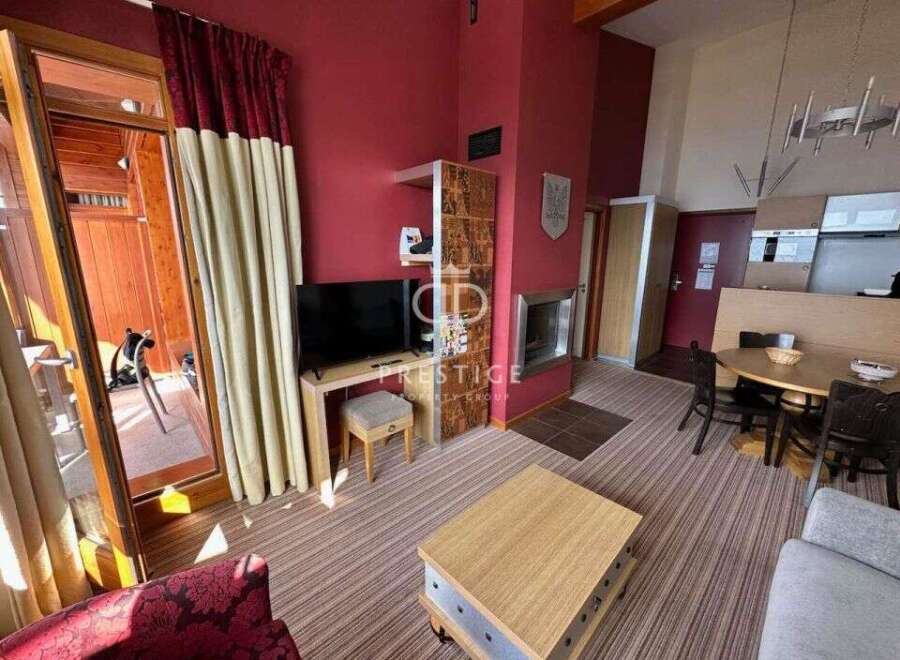 Discover a cozy living space with a fireplace, perfect for relaxing evenings.