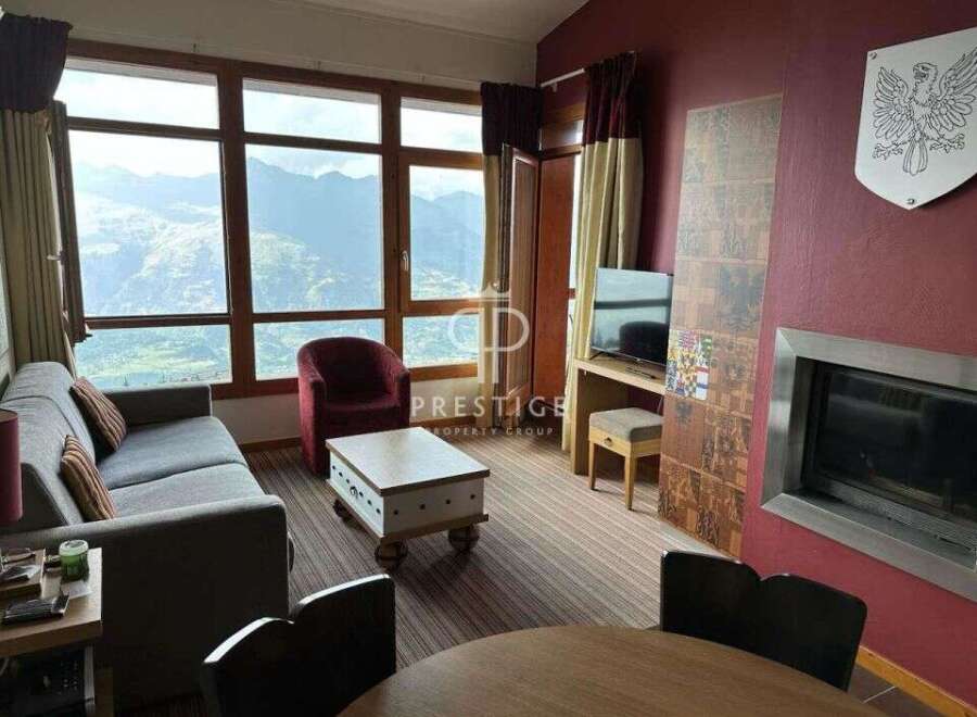 Experience breathtaking mountain views from this cozy living space.