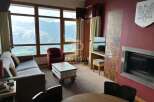 Experience breathtaking mountain views from this cozy living space.