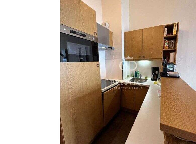 Discover a modern kitchen with sleek wooden cabinetry and integrated appliances.