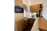 Discover a modern kitchen with sleek wooden cabinetry and integrated appliances.