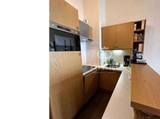 Discover a modern kitchen with sleek wooden cabinetry and integrated appliances.