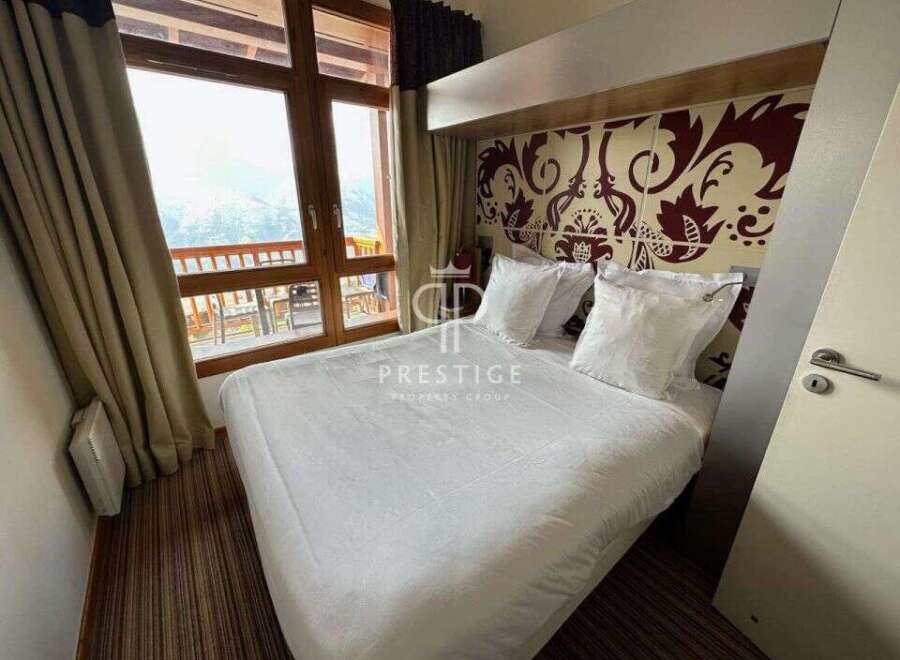 Experience luxury in this stunning property, featuring a cozy bedroom with a comfortable bed and elegant decor.