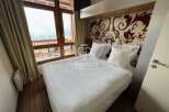Experience luxury in this stunning property, featuring a cozy bedroom with a comfortable bed and elegant decor.