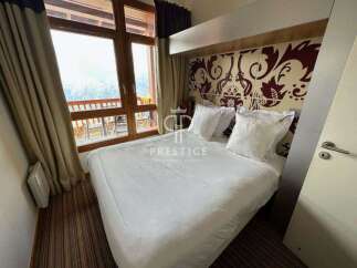 Experience luxury in this stunning property, featuring a cozy bedroom with a comfortable bed and elegant decor.