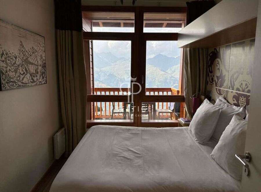 Experience breathtaking mountain views from this cozy bedroom.