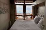 Experience breathtaking mountain views from this cozy bedroom.