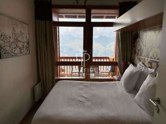 Experience breathtaking mountain views from this cozy bedroom.