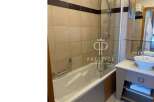 Discover a modern bathroom featuring a sleek bathtub and a stylish glass shower enclosure.