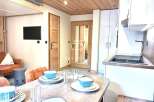 Discover a cozy and stylish property featuring a modern kitchen with sleek cabinetry and a functional sink.