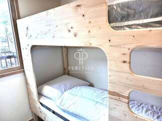 Discover the charm of this cozy bunk bed, perfect for maximizing space in any room.