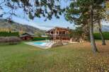 Discover a luxurious chalet nestled in a picturesque mountain setting.