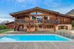 Discover luxury living in this stunning wooden chalet, complete with a private pool and breathtaking mountain views.