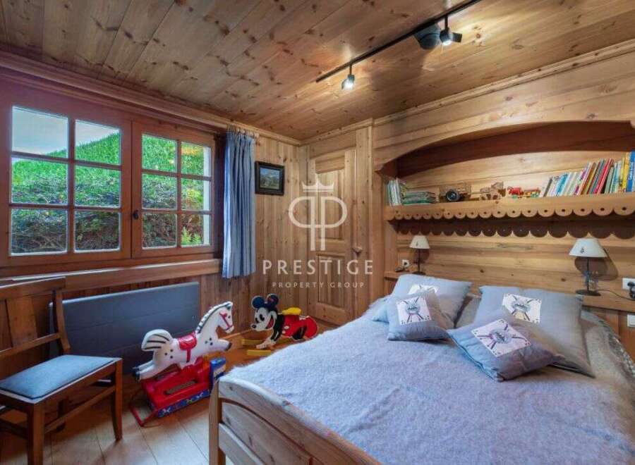 Discover the charm of this cozy bedroom, featuring warm wooden accents and a serene atmosphere.