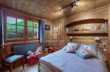 Discover the charm of this cozy bedroom, featuring warm wooden accents and a serene atmosphere.