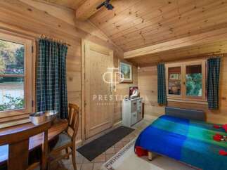 Discover the charm of this cozy cabin retreat, featuring warm wooden interiors and a welcoming atmosphere.