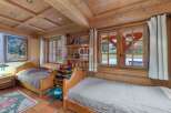 Discover the charm of this cozy bedroom, featuring warm wooden accents and a rustic ambiance.