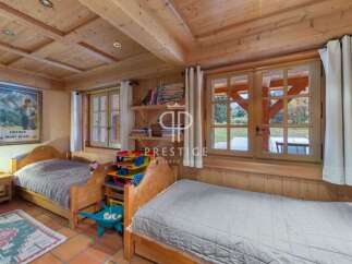 Discover the charm of this cozy bedroom, featuring warm wooden accents and a rustic ambiance.