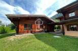 Discover a stunning wooden chalet nestled in a picturesque setting.