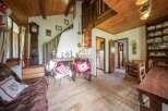Discover the charm of this cozy home, featuring a warm wooden interior and a welcoming fireplace.