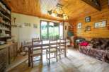 Discover the charm of this cozy cabin, featuring a warm wooden interior and a welcoming atmosphere.