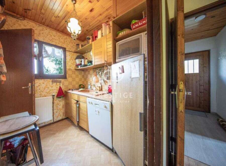 Cozy kitchen with wooden cabinets and a microwave.