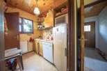 Cozy kitchen with wooden cabinets and a microwave.